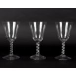 Three air-twist goblets, possibly circa 1750, the round funnel bowls on single spiral stems, 20.