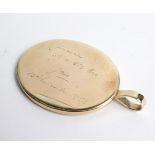 An oval pendant with initials LX inscribed 'Lawrence with a little love Jane, 12th November 1953',