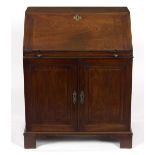 A mahogany bureau with cupboard under,