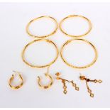 Four yellow gold bangles and a pair of gold earrings, all marked 916, approximately 19.