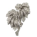 A diamond double clip brooch of floral form, the principal cushion shaped stone of approximately 1.