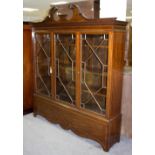 An Edwardian mahogany bookcase with astragal glazed doors and swan neck pediment