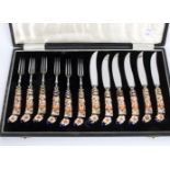 A set of Six Royal Crown Derby dessert knives and forks,