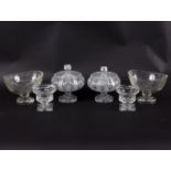 A pair of cut glass jars and covers of compressed globular form, 18cm high, a pair of oval bowls,