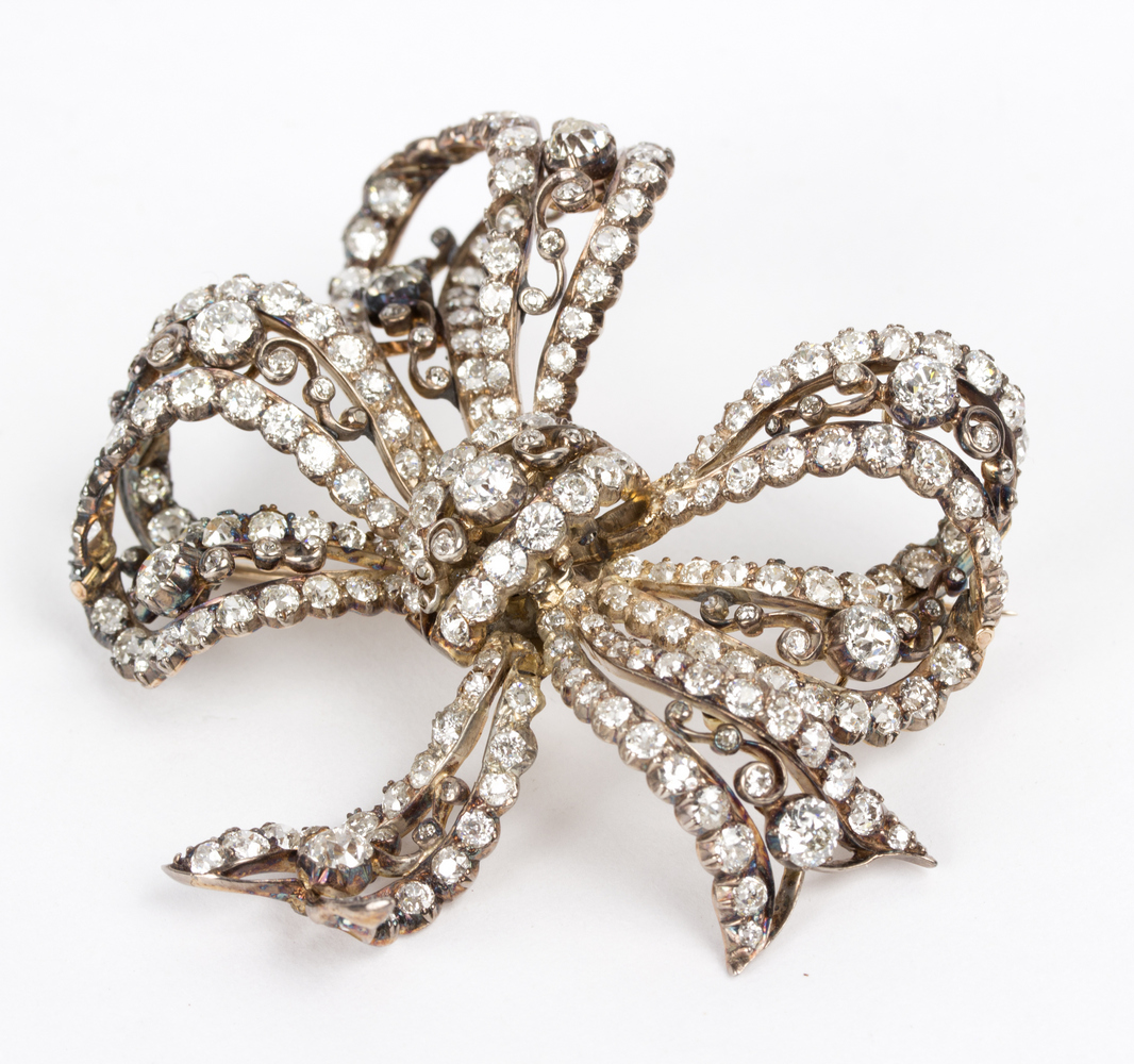 A Victorian diamond bow brooch, possibly adapted, one stone missing, 6cm wide,