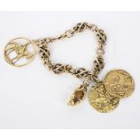 A 9ct gold fancy link bracelet hung with an 18ct gold monkey charm,