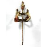 A painted, carved wood, textile and wire figurative folk-dancing prop,