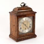 A walnut cased mantel clock by Elliott,