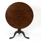 An early 19th Century circular mahogany table on a gun barrel column and tripod supports,