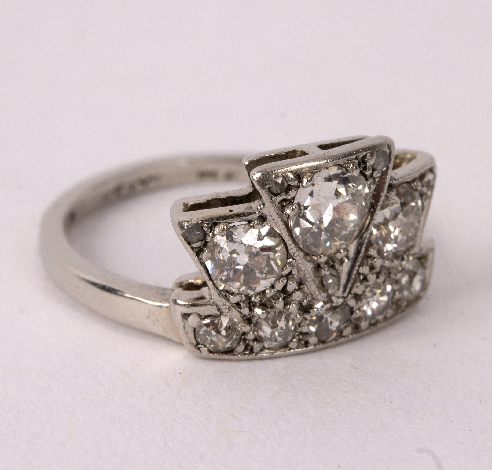 An Art Deco diamond ring of stylised coronet design, the principal stone 0.