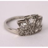 An Art Deco diamond ring of stylised coronet design, the principal stone 0.