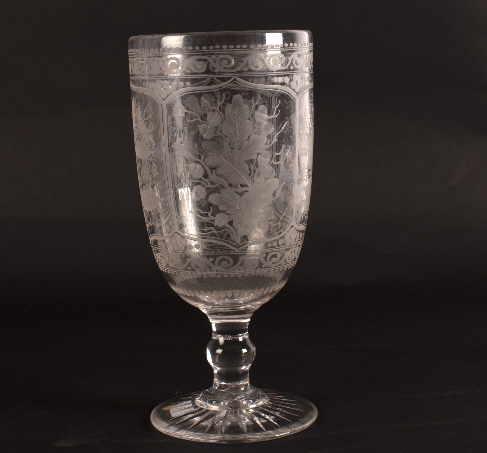 An engraved celery glass on a circular star cut base, 24.