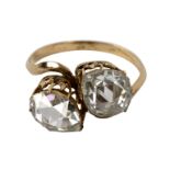 A diamond crossover ring, the two pear-shaped stones to a later yellow gold shank,