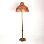 An Art Nouveau brass standard lamp with Tiffany style shade,