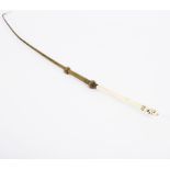 A plaited brass riding whip,