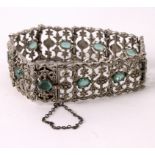 An Italian marcasite gate-link bracelet set with ten oval pale green stones and safety chain