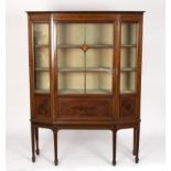 An Edwardian glass fronted cabinet, with central glazed bar door and canted sides,