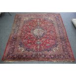 A Kashan rug, the central medallion to a crimson ground within a multiple border,