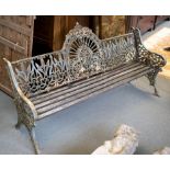 A late 19th Century cast iron garden seat, interwoven back and arms and having a slatted seat,