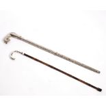 An Edwardian bamboo cane, the plain silver handle London 1901 and a white metal walking stick,