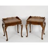 A pair of reproduction walnut single drawer side tables on cabriole legs,