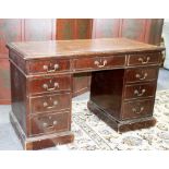 A mahogany twin pedestal desk with leather set top, fitted a surround of nine drawers,