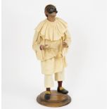 A Neapolitan painted terracotta figure of Punchinello, fully clothed wearing a mask,