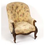A Victorian walnut framed button back armchair with floral and scroll carving Condition