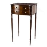 A Regency side table of serpentine outline, fitted two drawers on reeded taper legs, 42.