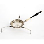 An unusual silver tea strainer, circa 1888, with Swedish marks, fine ebony and ivory handle,