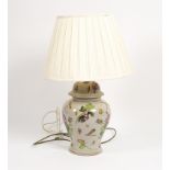 A vase shaped floral table light with shade