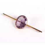 An amethyst bar brooch, the large oval stone approximately 23mm x 19mm x 9mm,
