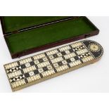An 19th Century ebony and ivory inlaid cribbage board with brass edge on turned feet, 35.