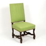 A Flemish style chair with upholstered back and seat to a carved and moulded frame,