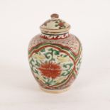 A Chinese wucai jar, circa 1650, with well matched cover, the ovoid jar decorated in yellow,