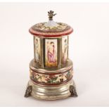 A Capo di Monte style musical cigar dispenser, with cherub finial,