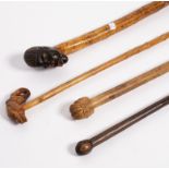 A walking stick, the carved wooden handle modelled as the head of an African man,