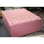 A large button upholstered Ottoman on four bun feet, 122cm x 91.