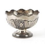A silver rose bowl, Chester 1903, with wavy rim and embossed flowers and scrolls to the sides,