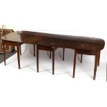 A George III mahogany D end dining table on square tapering supports with central drop flap section,