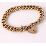 A 9ct gold curb link bracelet with heart-shaped padlock clasp,
