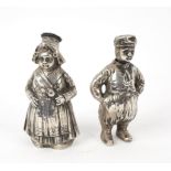 A pair of Dutch 800 standard silver pepper pots, modelled as a boy and a girl, circa 1880,