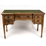 An early 20th Century breakfront writing table, on square tapering legs,