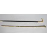 A whalebone walking stick with ivory handle and an ebonised walking stick,