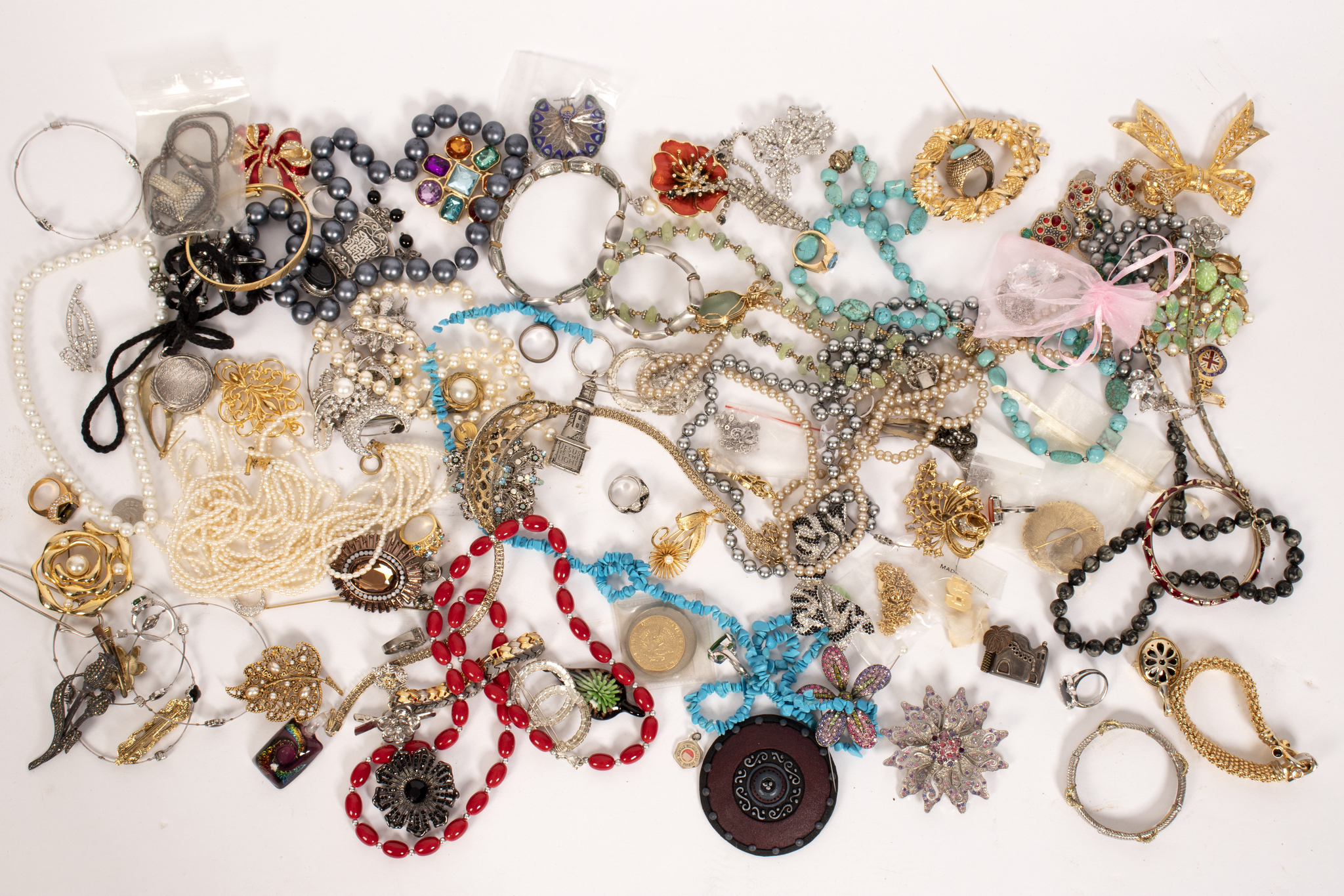 A quantity of costume jewellery including enamelled peacock brooch,