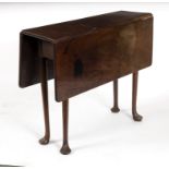 A George III mahogany drop flap table on pad feet,