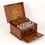 A 19th Century mahogany apothecary box by S Maw & Son, London, fitted with scales, weights, files,