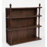 A mahogany hanging bookcase of three shelves with knulled borders united by turned columns to the