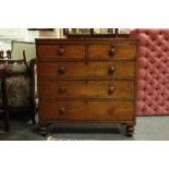 A Victorian mahogany chest of two short and three long drawers, with turned handles and feet,