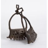 A pair of early 19th Century iron stirrups, probably Iberian, with pierced decoration to the sides,